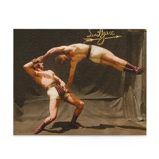 Two Les Ajax acrobats in cream costumes and burgundy boots perform a counterbalance lift before drapery, beneath a gold script inscription and arrow