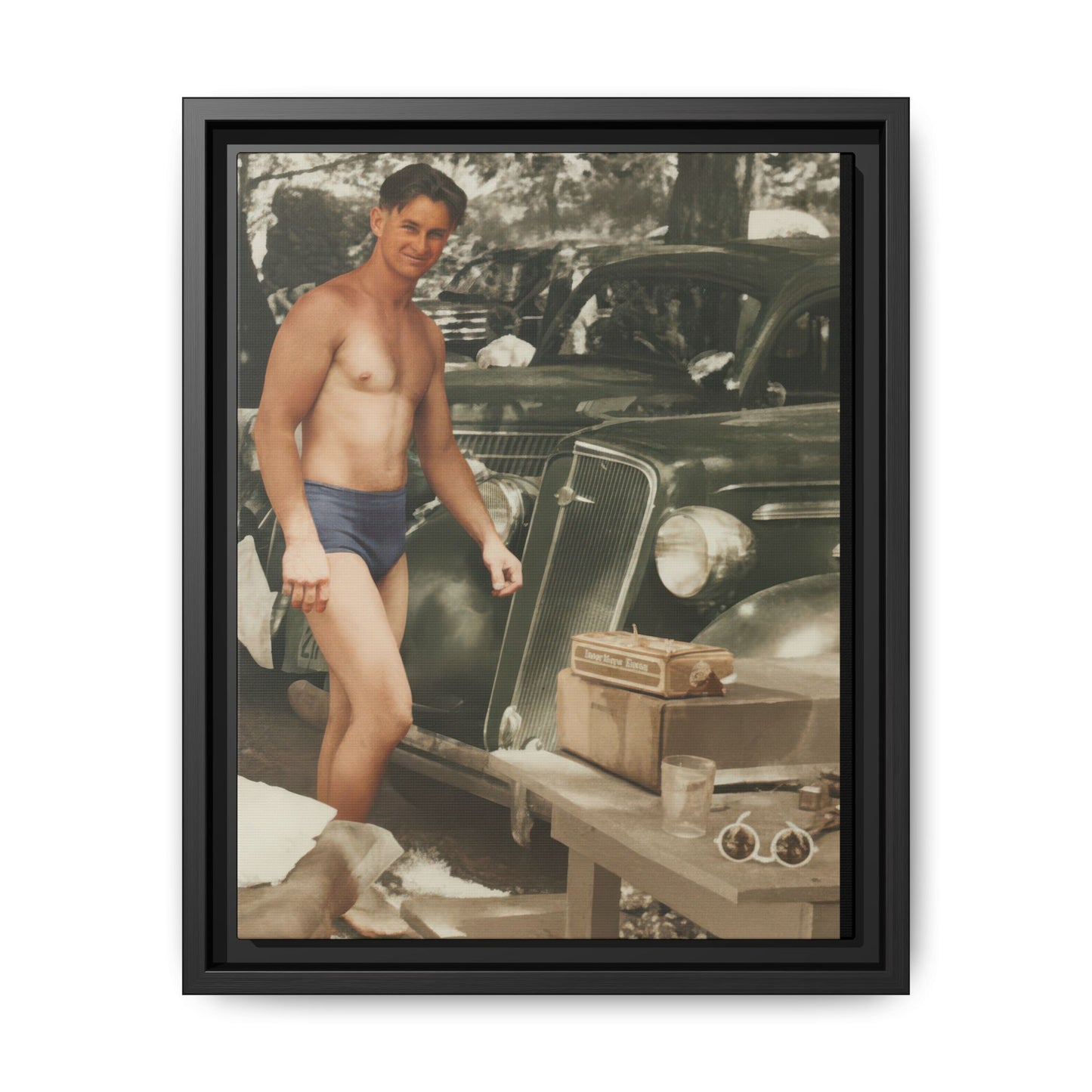 Framed vintage canvas wall art showing a standing bather beside parked automobiles 