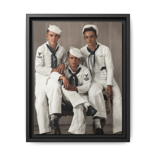 1Restored and colorized studio portrait of three men in white naval-style uniforms arranged around an upholstered wooden chair.