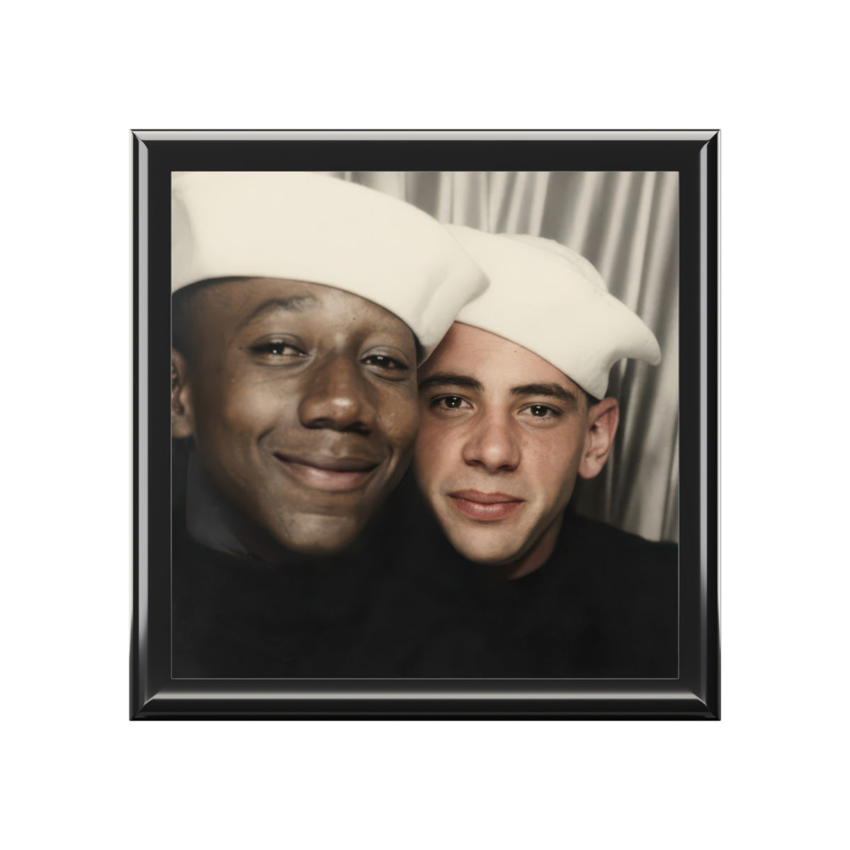 Closed wooden keepsake box viewed at an angle, with a vintage photobooth portrait of two Black sailors in white caps on the lid.