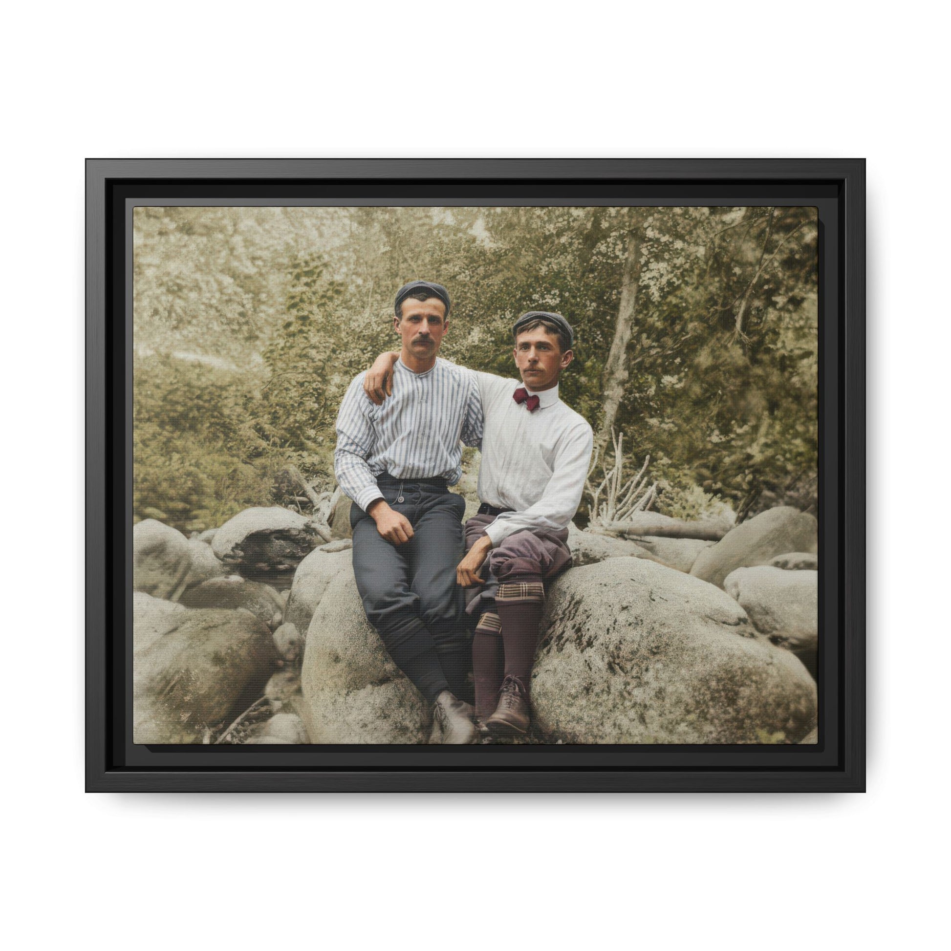 Early 20th century outdoor portrait two men seated on rock in forest setting