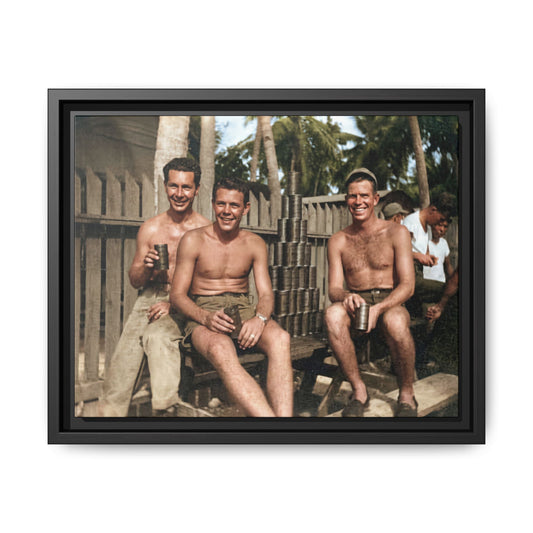 Restored historical photograph of three shirtless foreground men holding metal cups beside stacked tins, with a wooden fence and palms behind them.