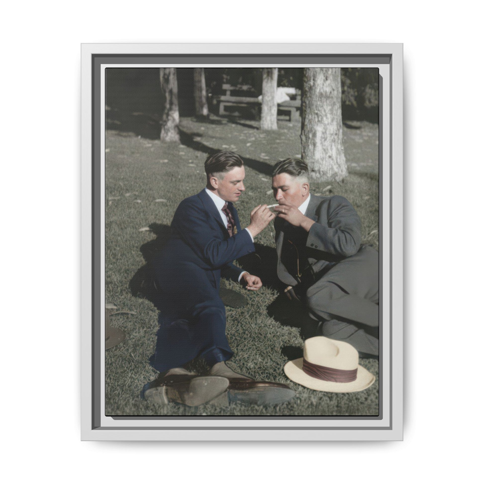Museum-style archival photo reproduction showing a historic outdoor portrait with tailored menswear and park setting