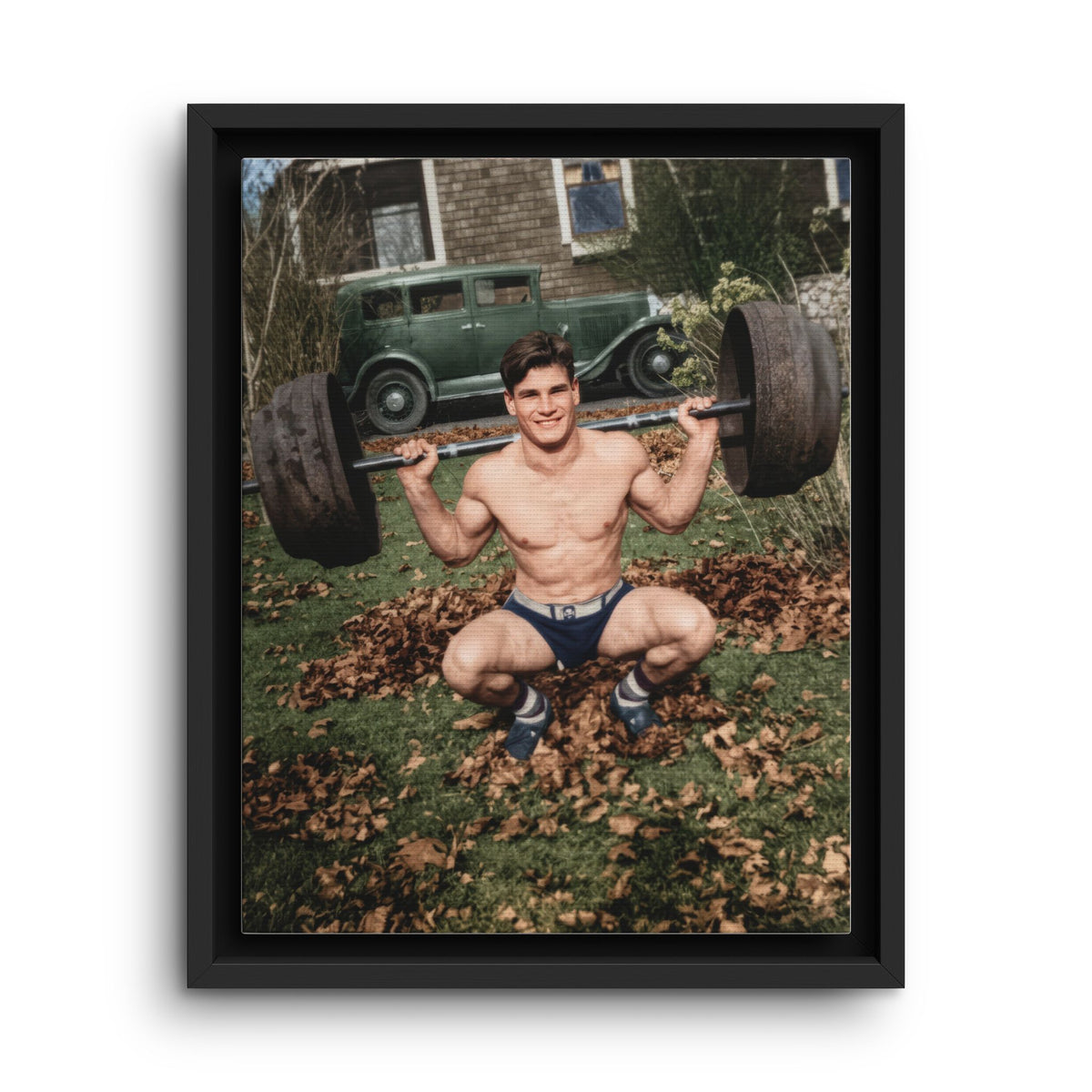 Vintage weightlifter performing a deep back-barbell squat outdoors beside a period automobile 